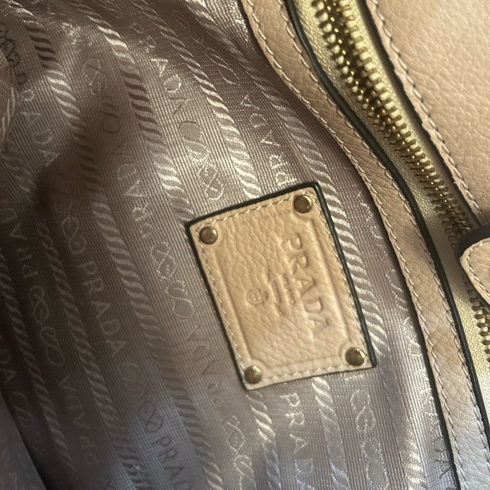Cream Prada handbag with some stains